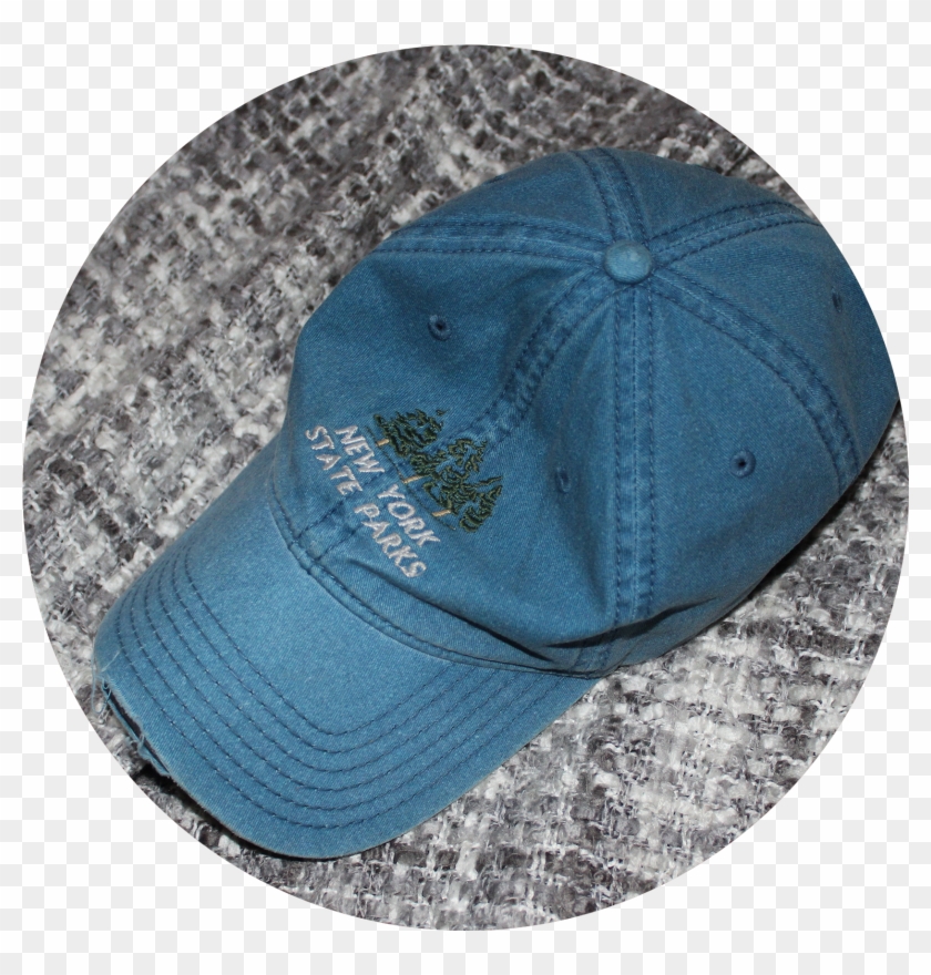 A Faded Dark Blue Jean Baseball Cap Sits On A Grey Baseball Cap